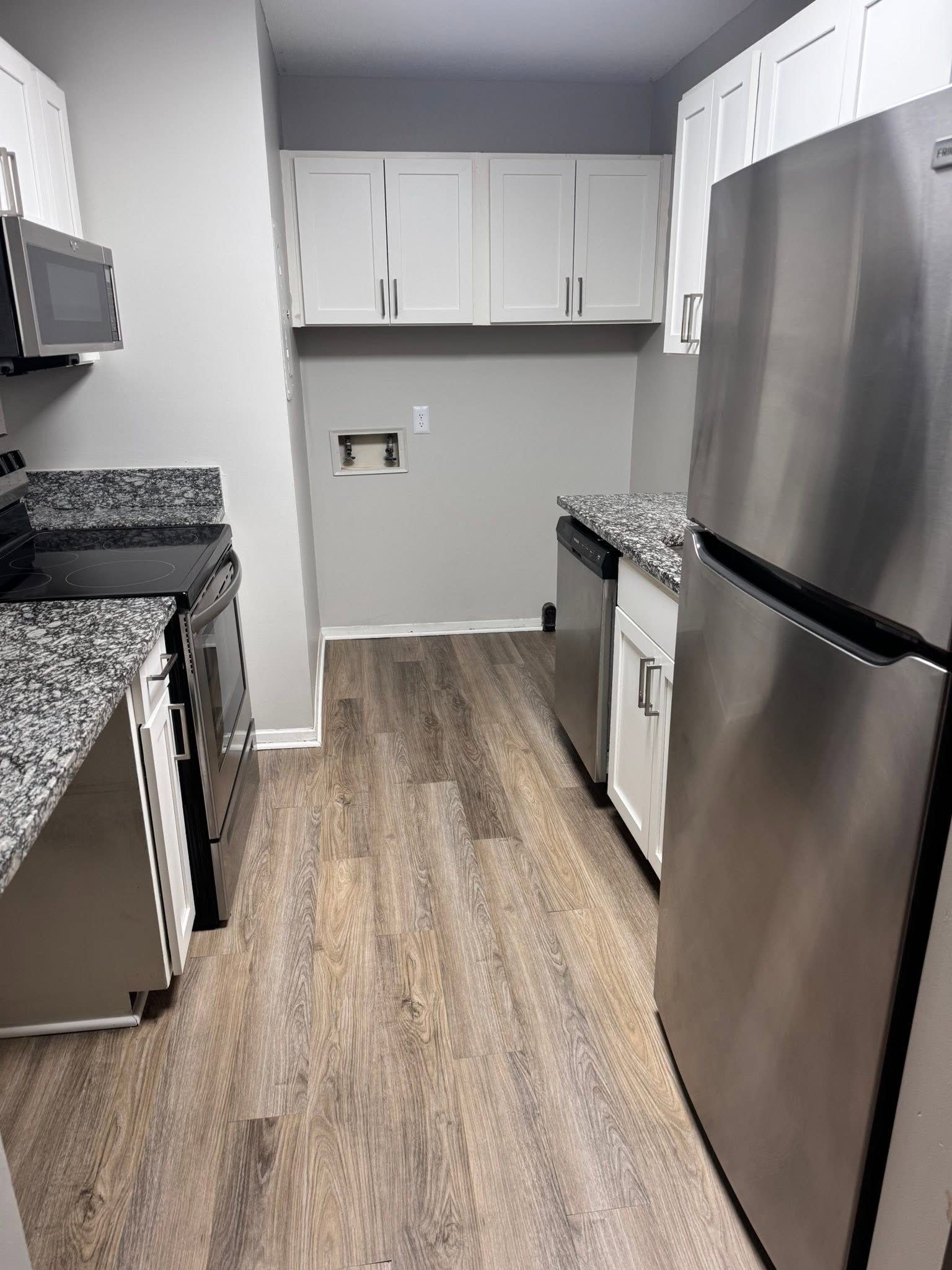 Clean kitchen with counters and appliances