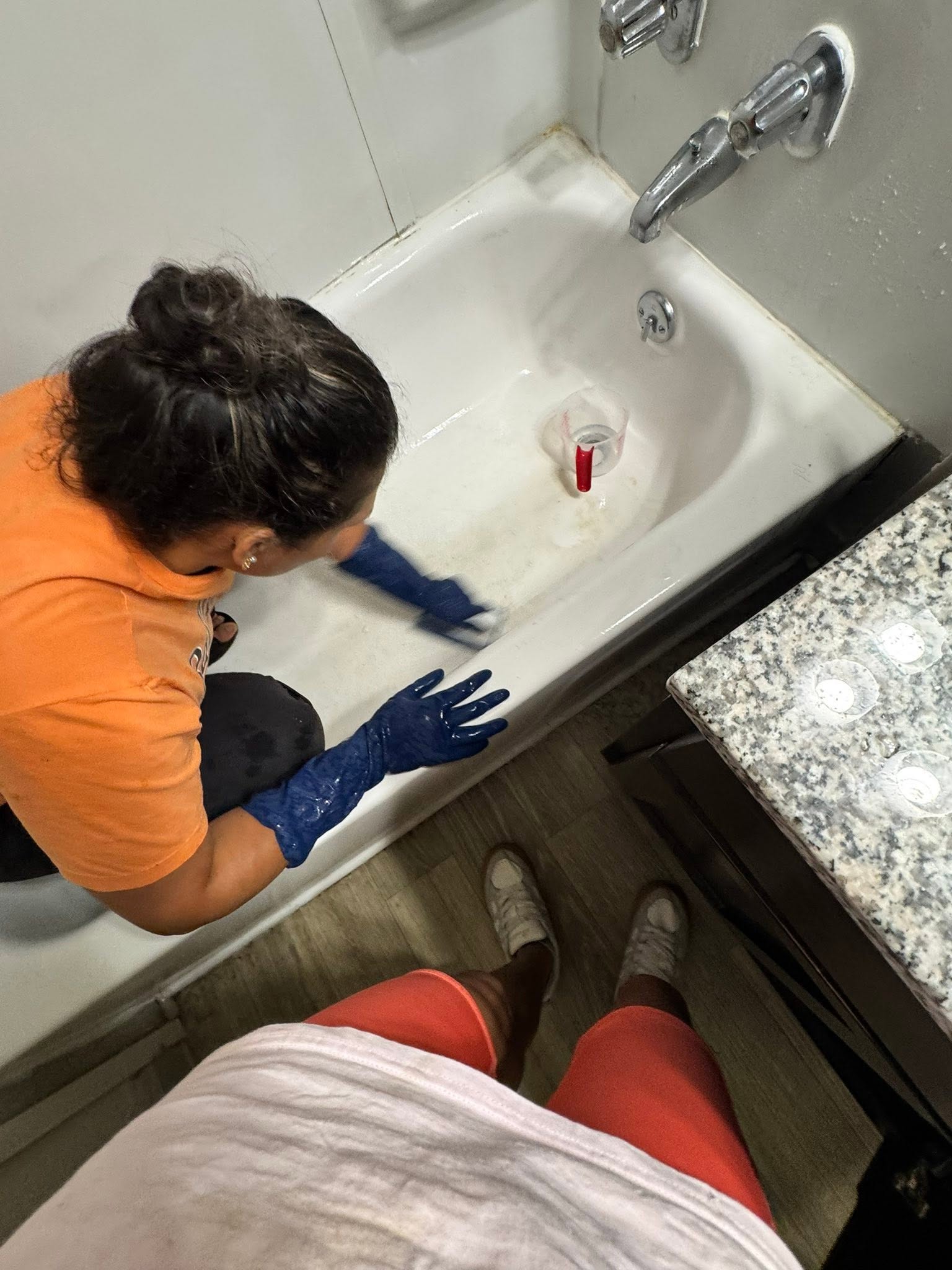 Worker cleaning a bathroom sink