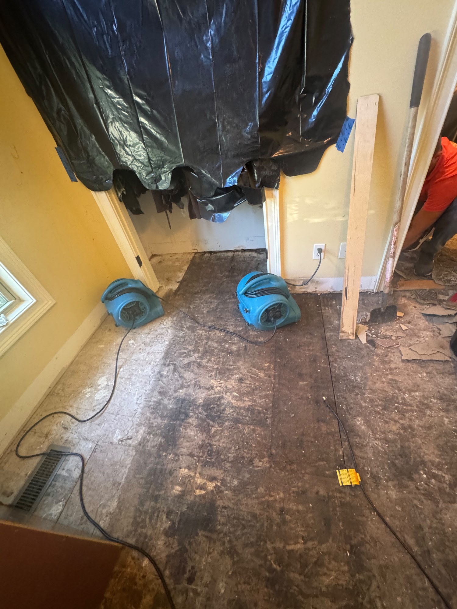 Interior demolition work area with protective equipment and tools