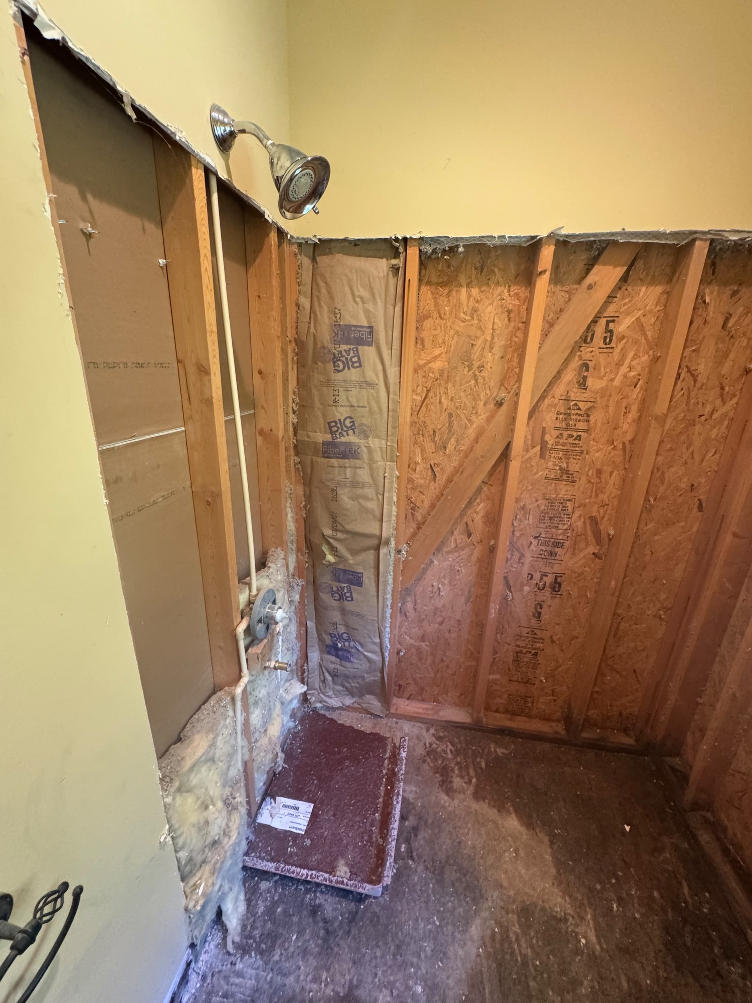 Interior demolition with exposed wall framing and removed drywall