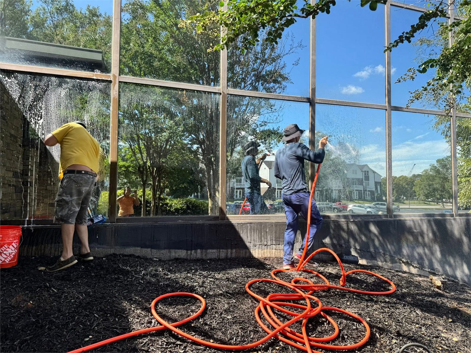 Cleaning workers performing exterior cleaning at a property